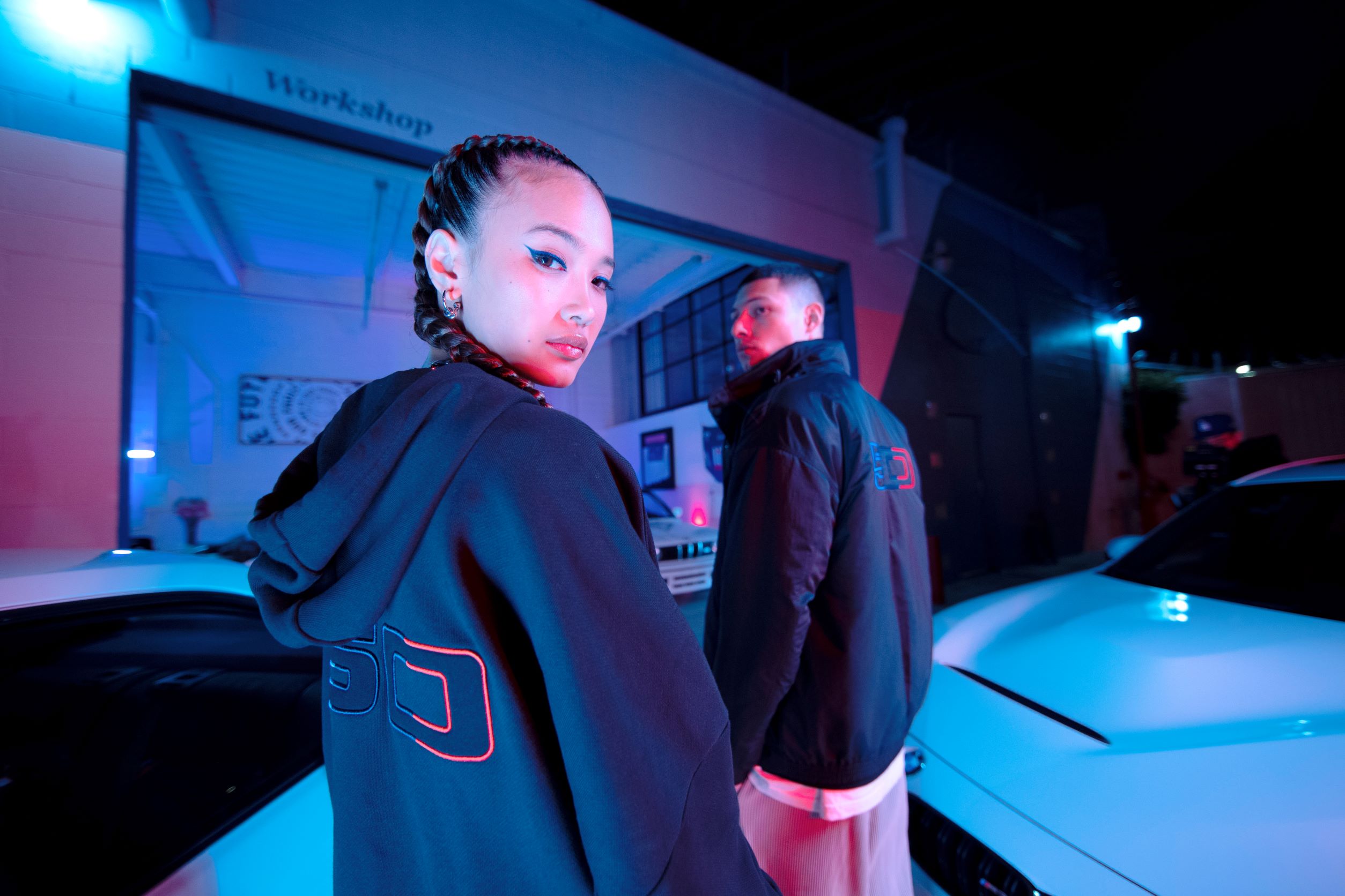 Models posing in the BMW 50 years of M collection by Puma