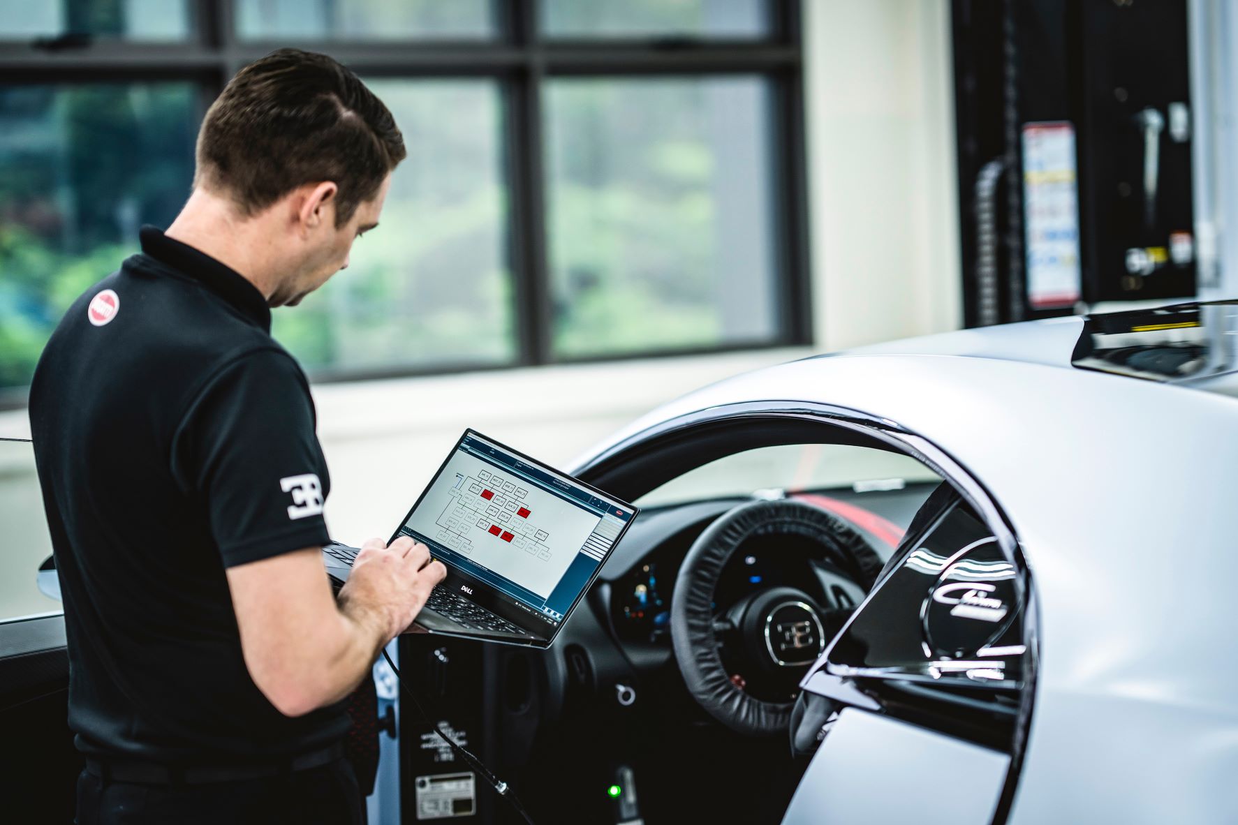 A Bugatti technician at work under the Certified Pre-Owned Program