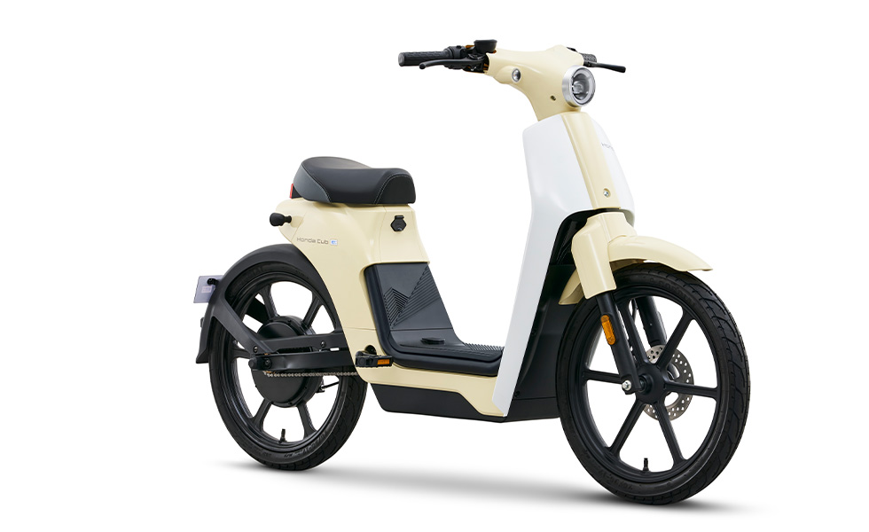 A photo of an electric Honda Cub e in cream colour on a white background.