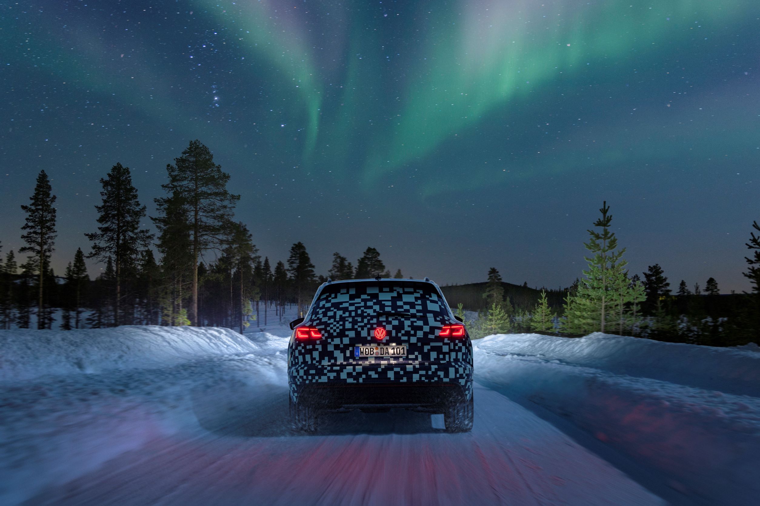 Rear view of the new Volkswagen Touareg being tested under the Northern Lights in Sweden