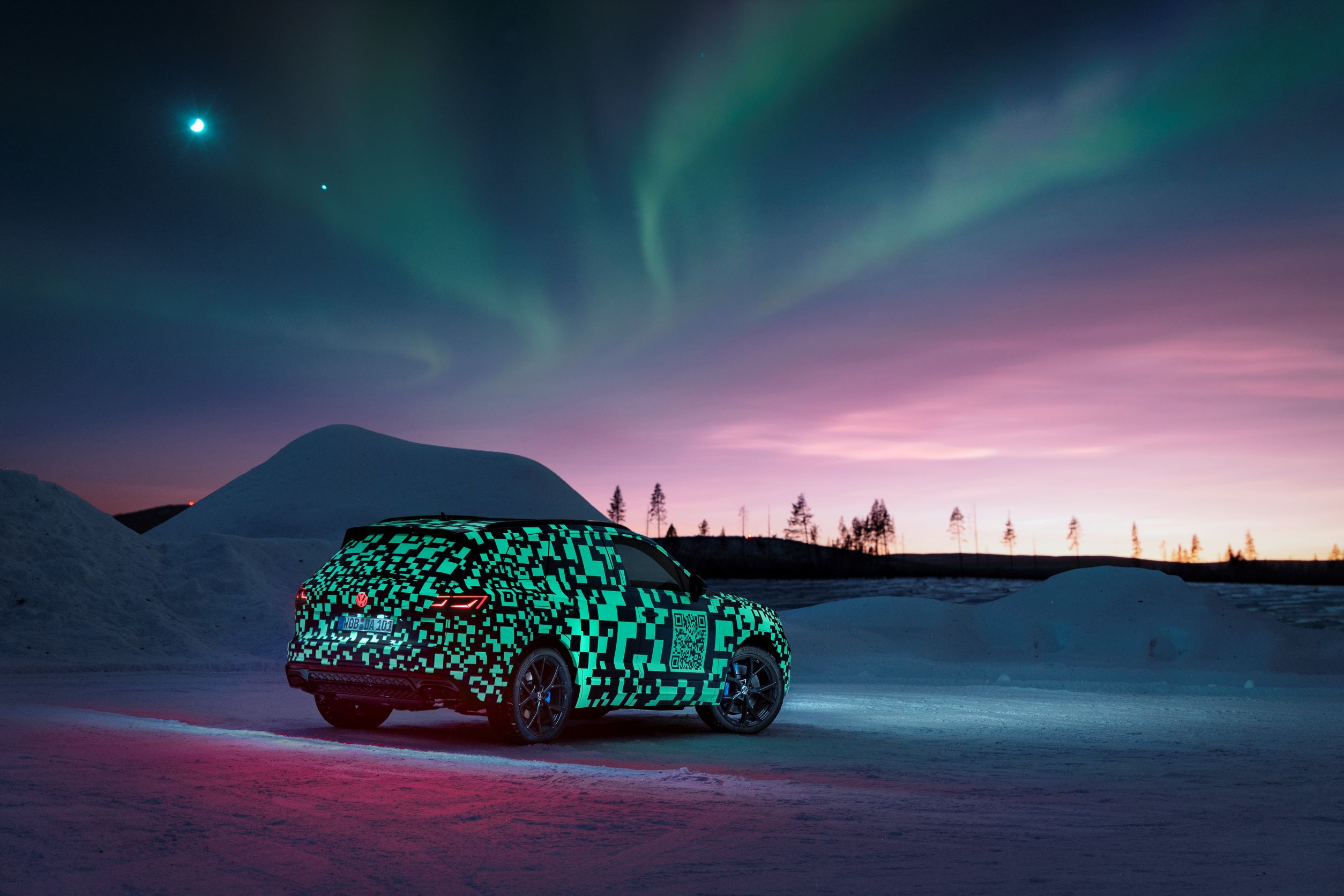 Rear three quarters view of the new Volkswagen Touareg being tested under the Northern Lights in Sweden.
