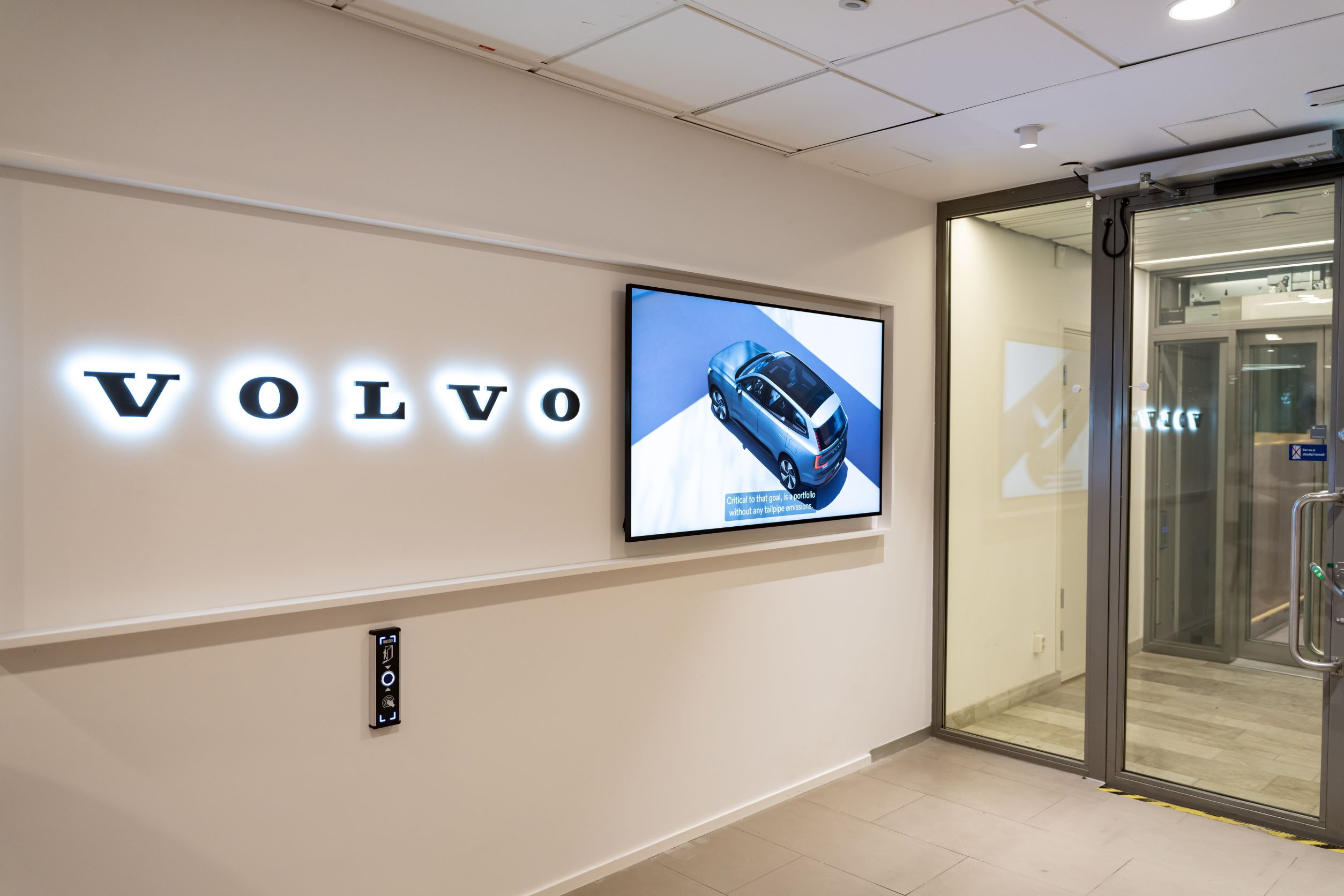 A photo of a lit Volvo logo at the company's HQ. 