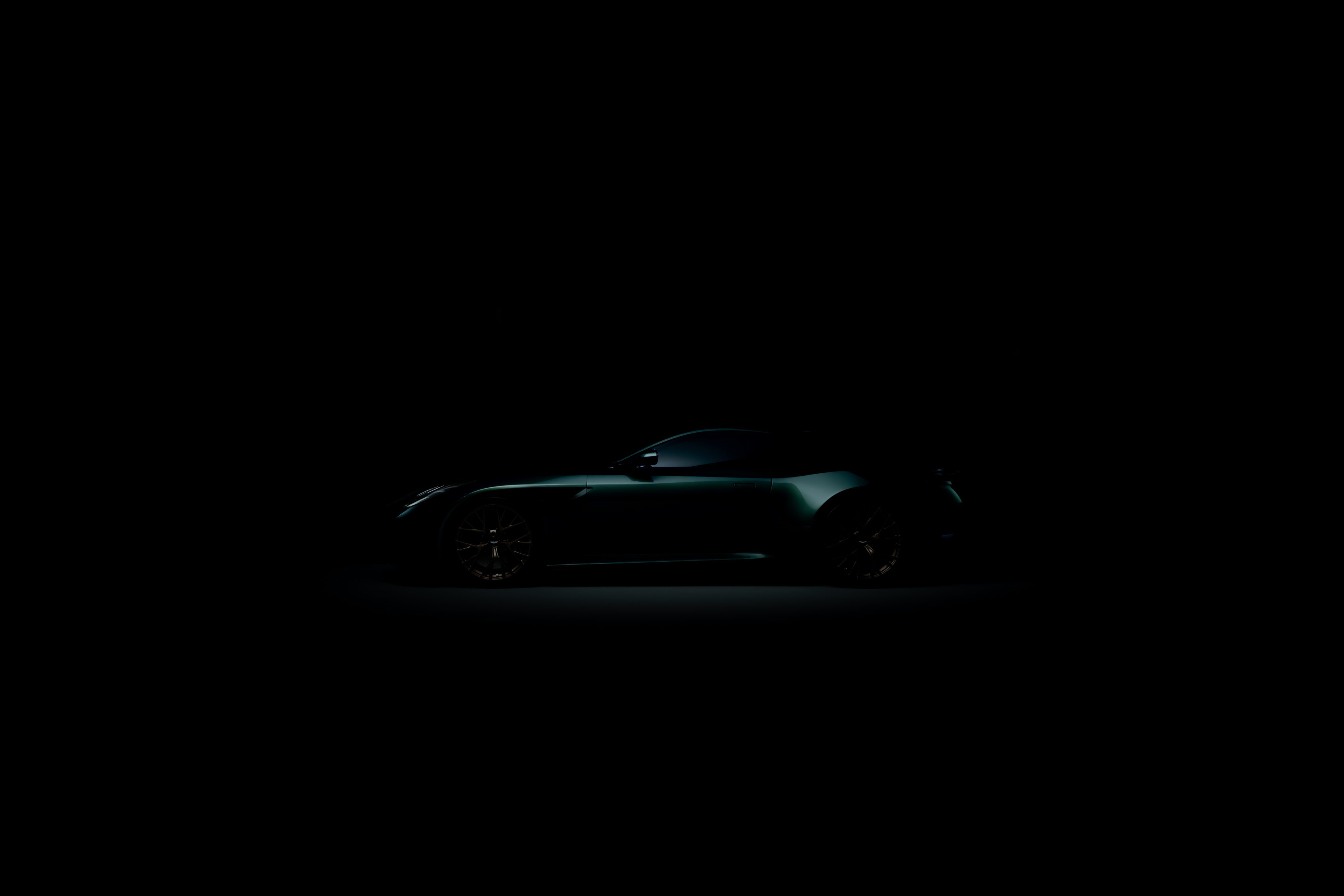 A view of the side profile of the new Aston Martin DB car in green from the teaser image. 