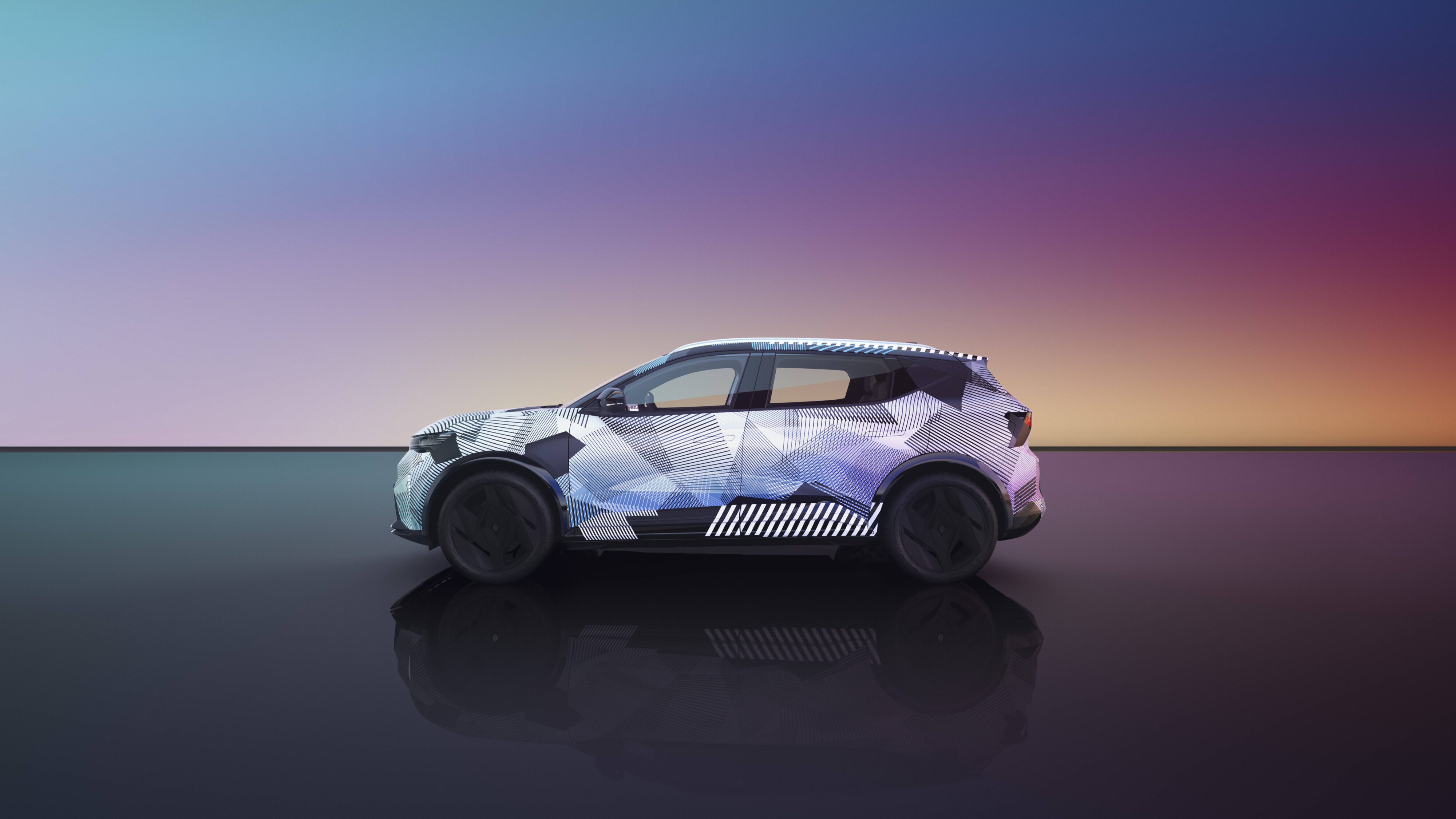 Side view of a camouflaged Renault Scenic E-Tech electric SUV