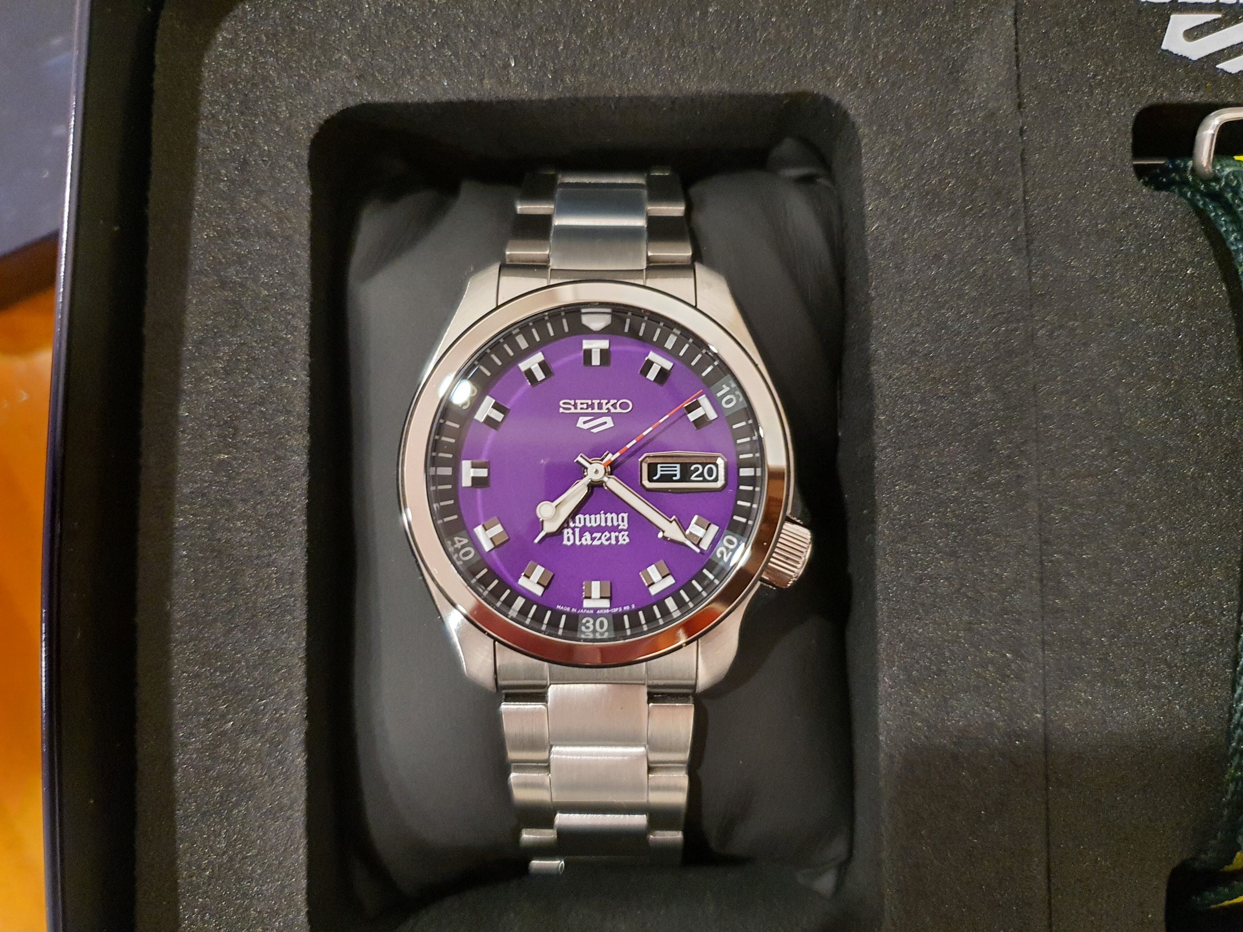 A close-up photo of the Seiko 5 x Rowing Blazers purple dial wristwatch