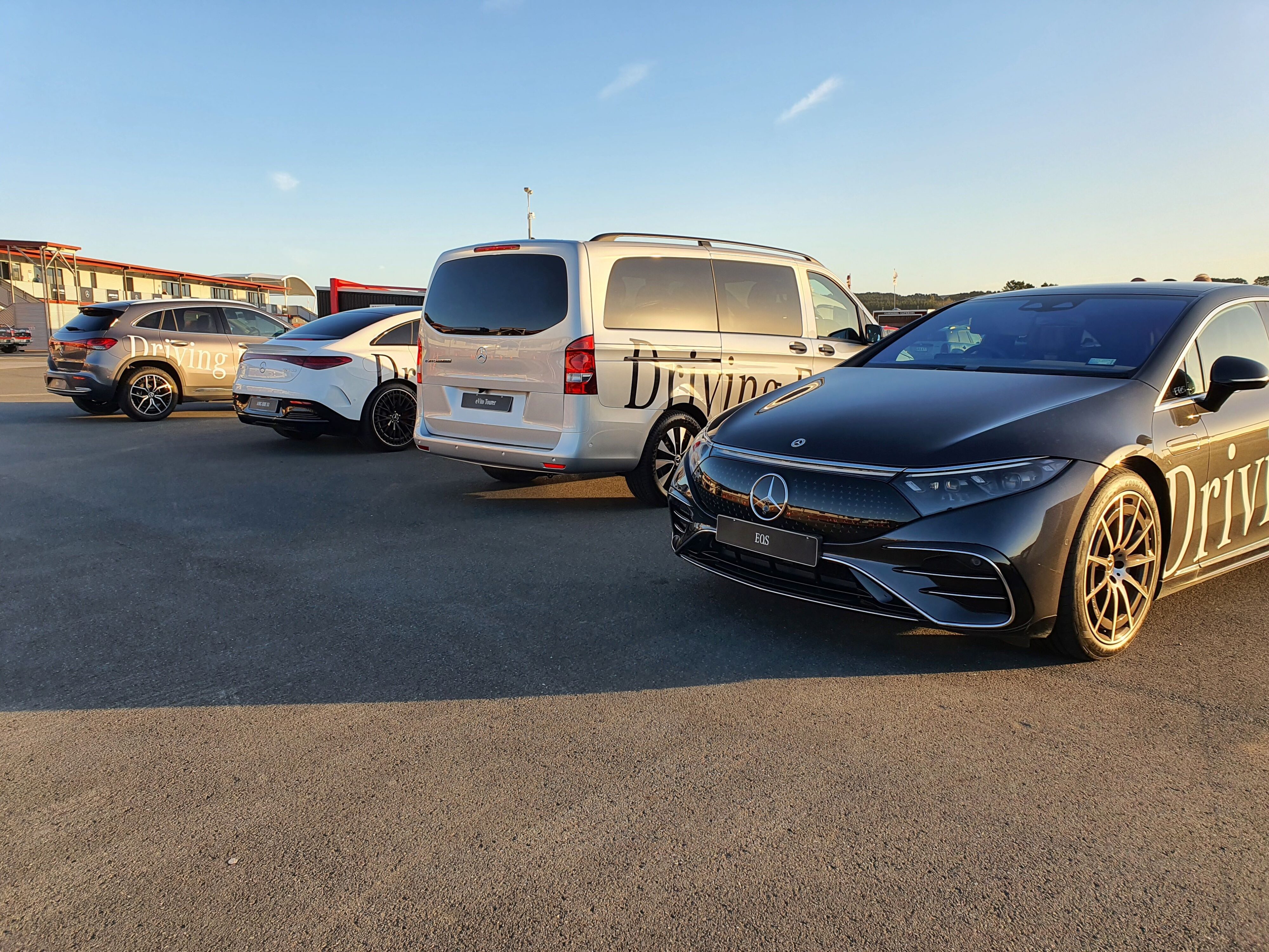 A range of Mercedes-EQ cars in frame including an EQS, eVito, EQE53AMG and EQA as part of Mercedes' Driving Event at Hampton Downs Motorsport Park NZ.