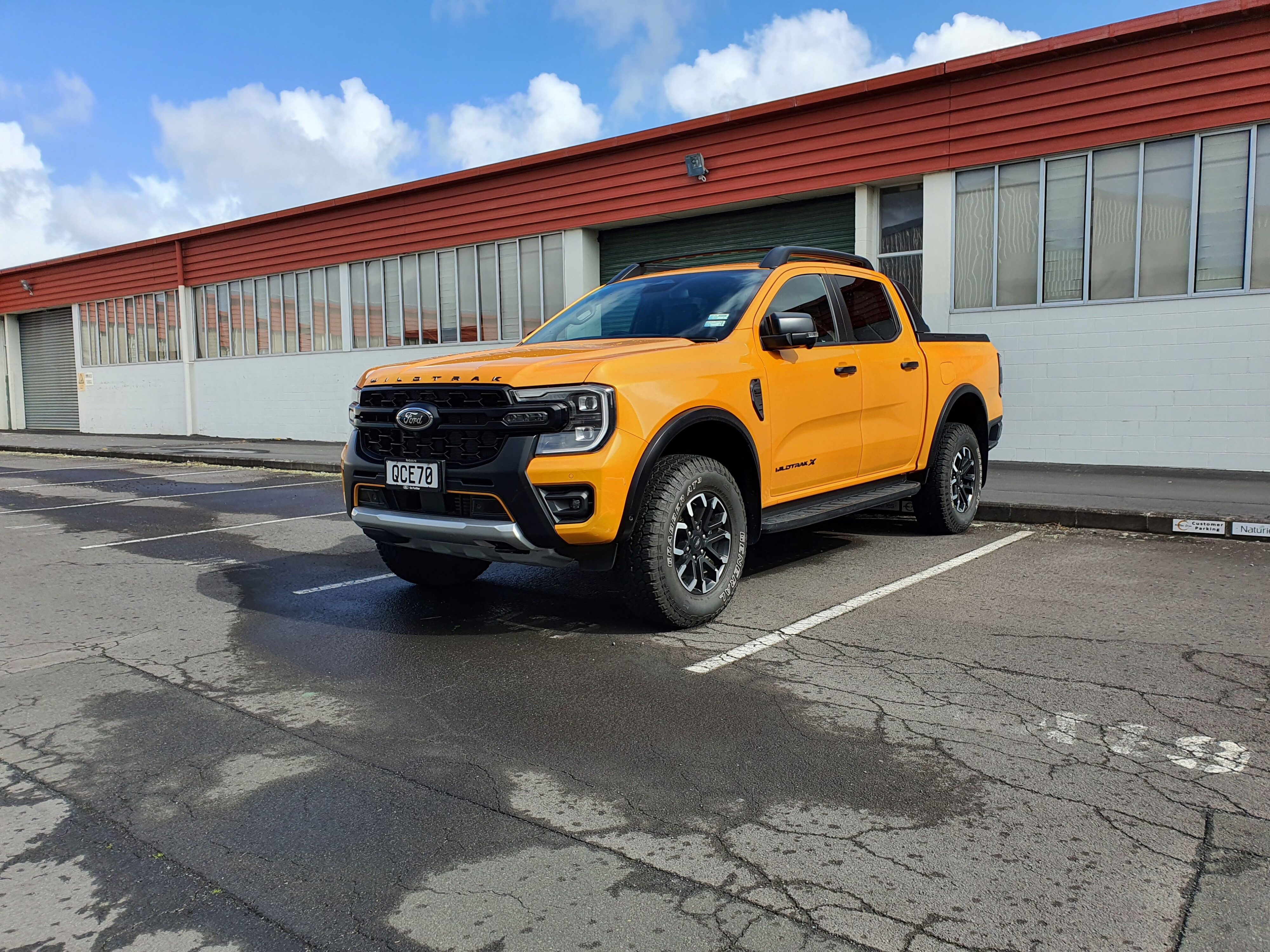 Front three quarters view of a 2023 Ford Ranger Wildtrak X in Cyber Orange.