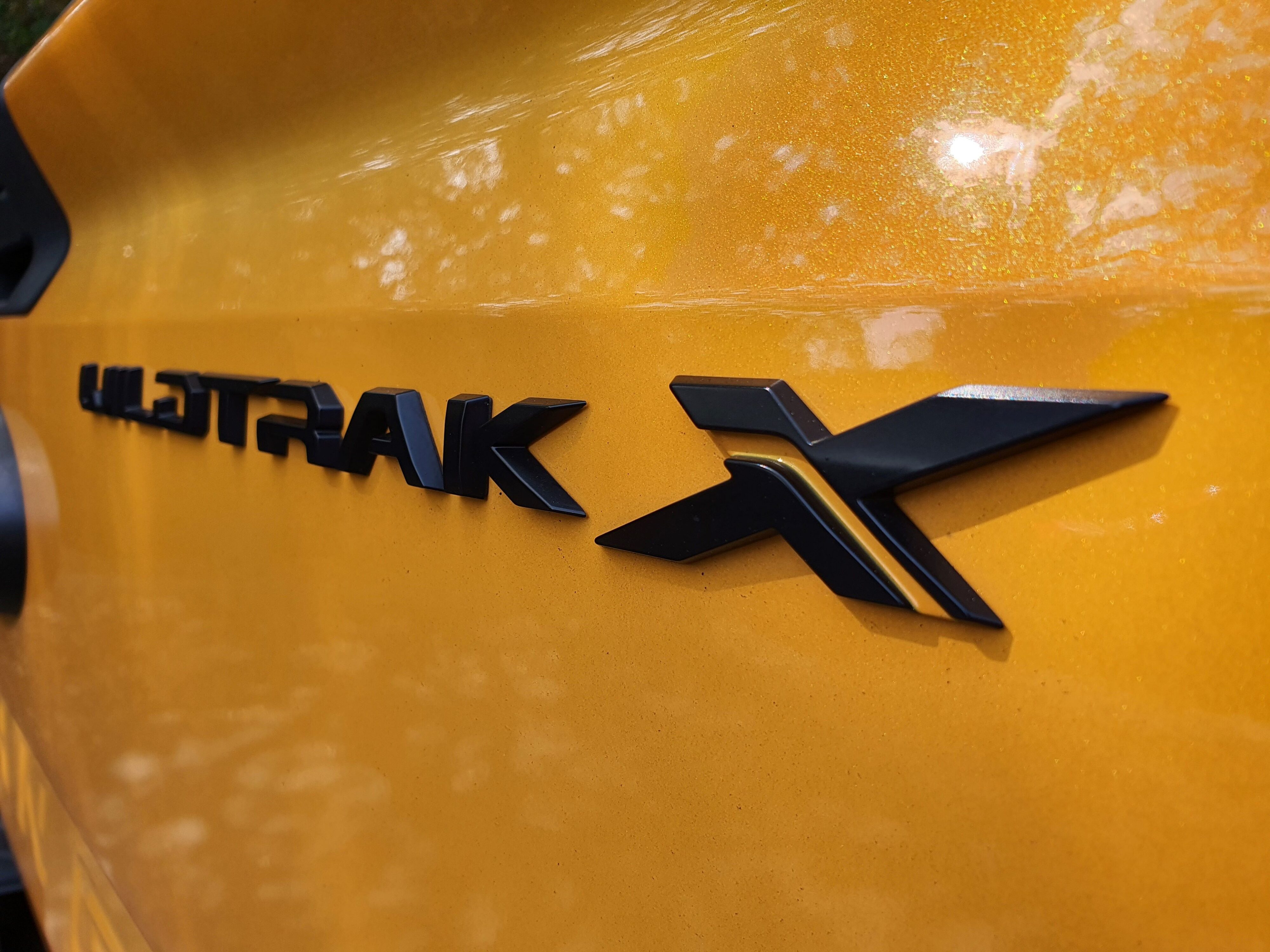 Black Wildtrak X badge on the tailgate of a 2023 Ford Ranger Wildtrak X in Cyber Orange.