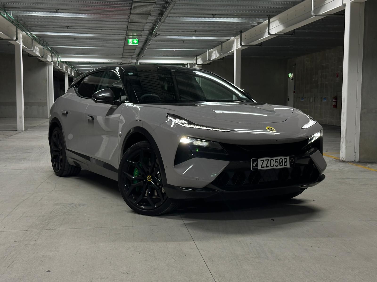 Front three quarters view of a 2024 Lotus Eletre R in Kaimu Grey in an underground carpark.