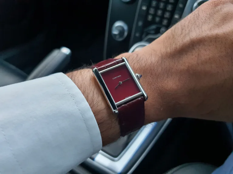 Cartier Tank in Claret (Burgundy), photographed on Matthew's left wrist.
