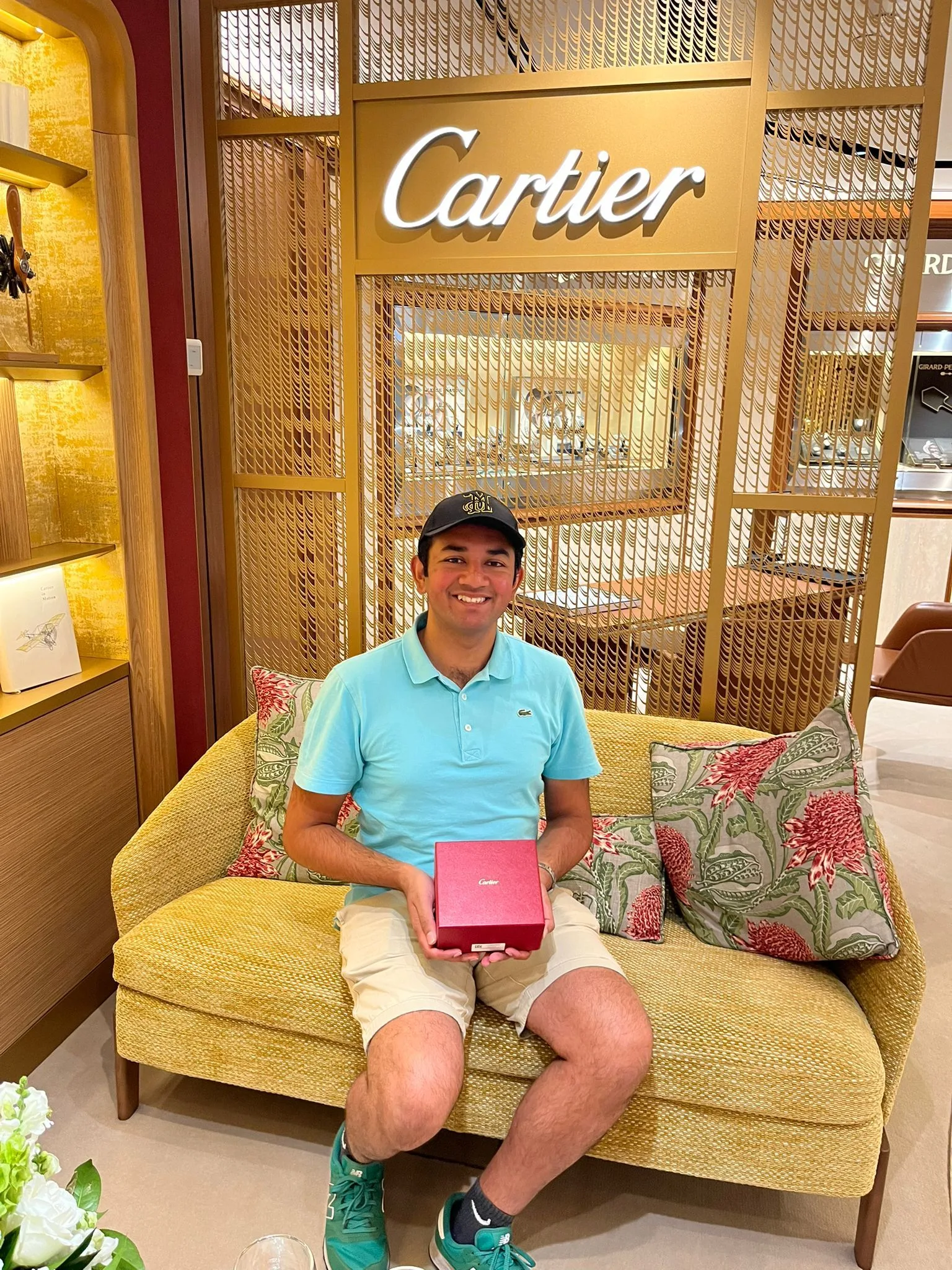 Matthew holding a watch box whilst sitting in front of the Cartier display inside The Hour Glass Sydney, Australia.