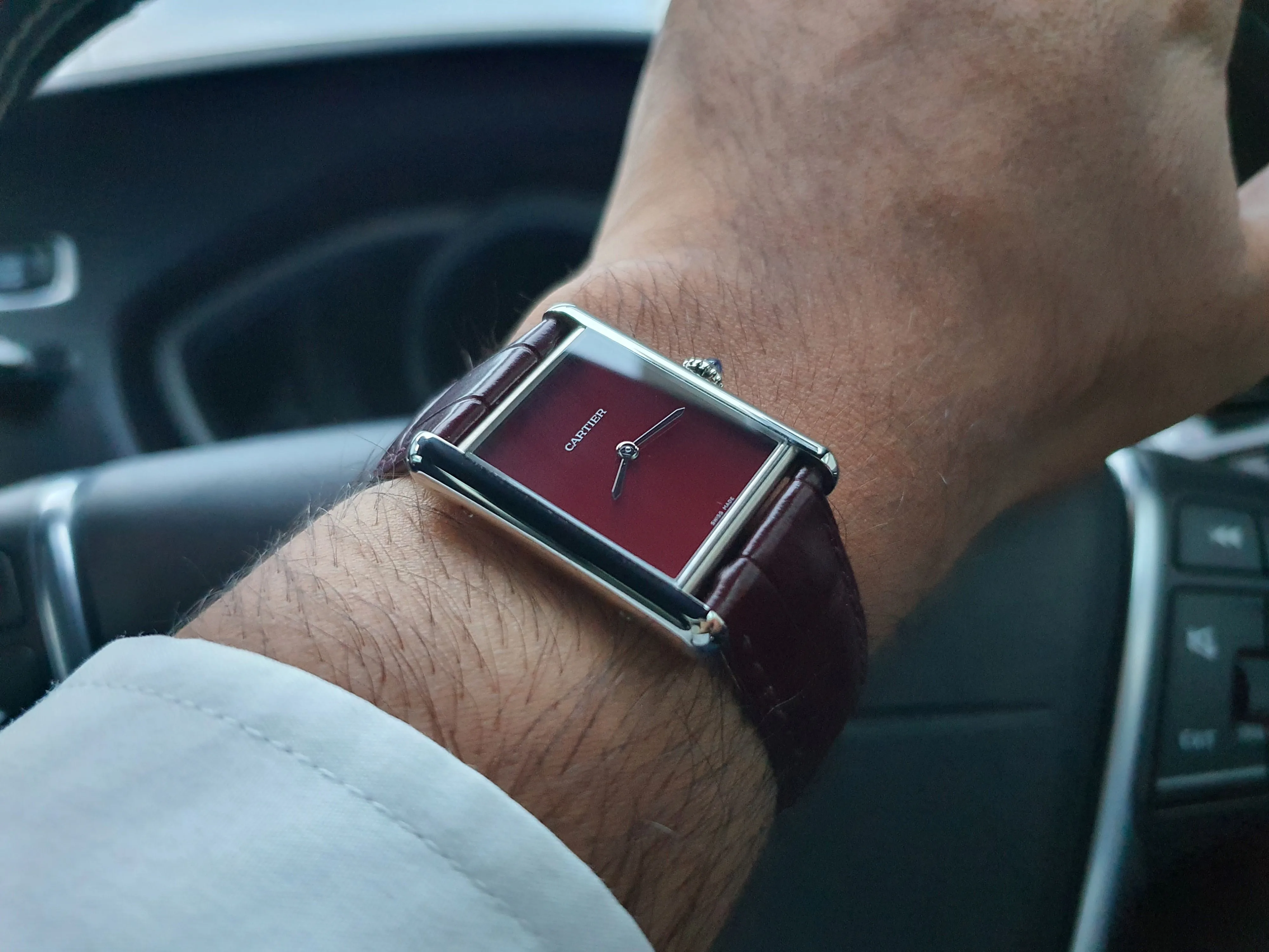 Cartier Tank in Claret (Burgundy), photographed on Matthew's left wrist.