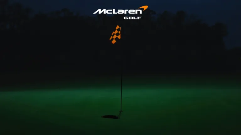 A promotional photo for McLaren Golf with an orange flag on a putting green.